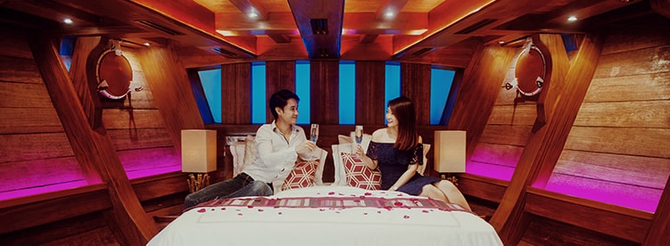 couple inside the cabin having champagne royal albatross