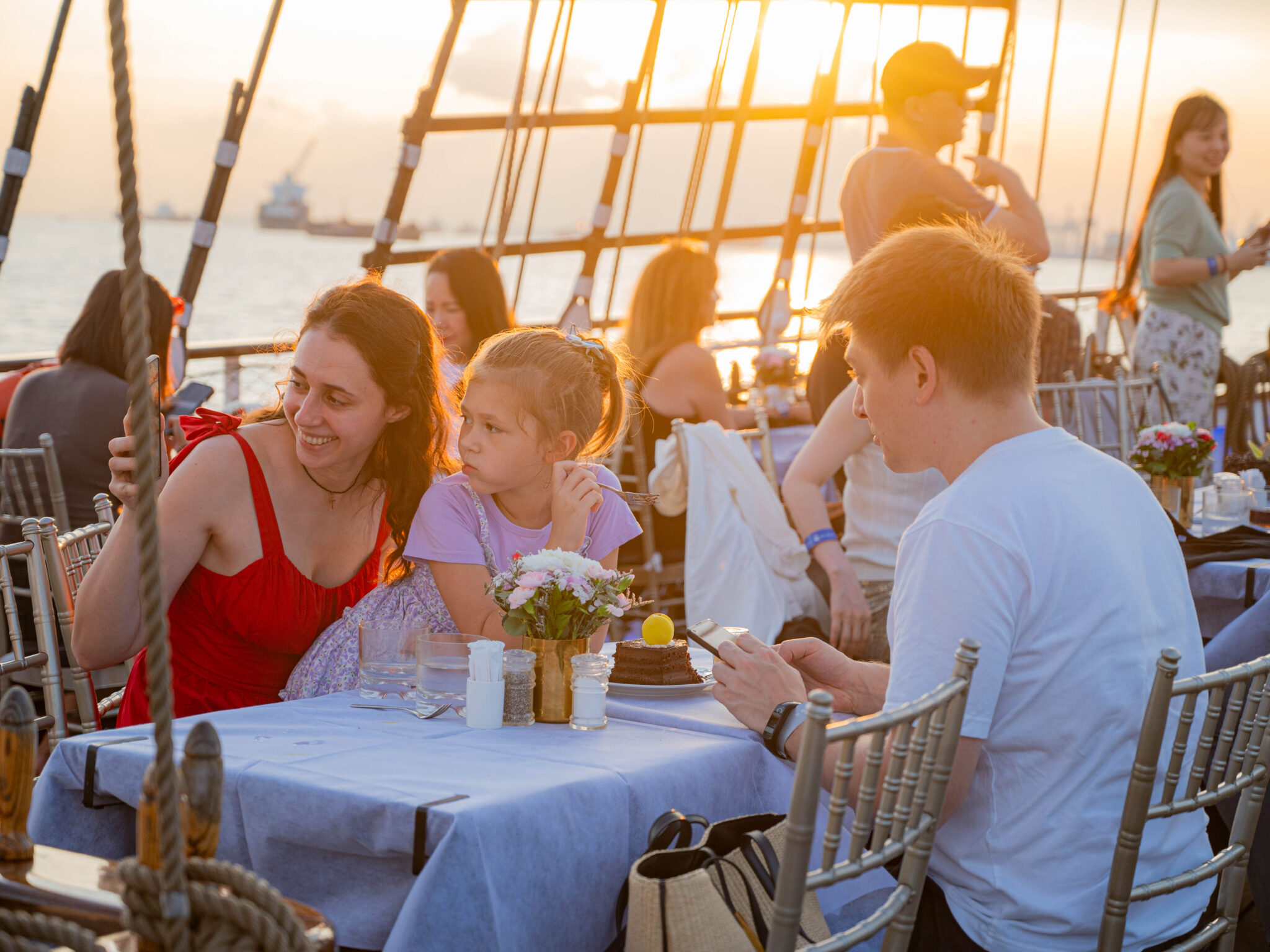 Families enjoying dining experience on Royal Albatross cruise under the stars for SG60 National Day celebration